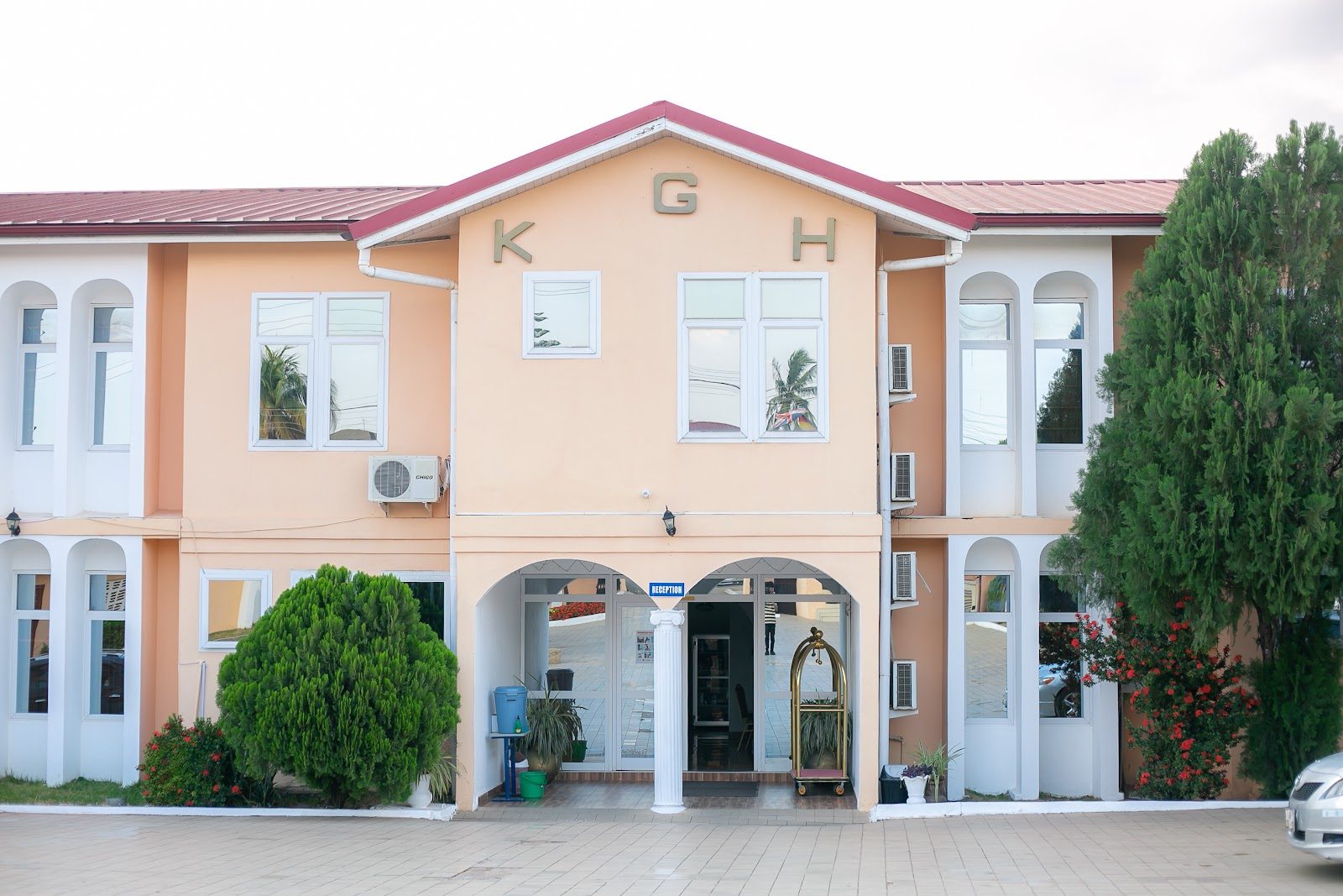 The peach-coloured arched façade of Koforidua Guest Hotel