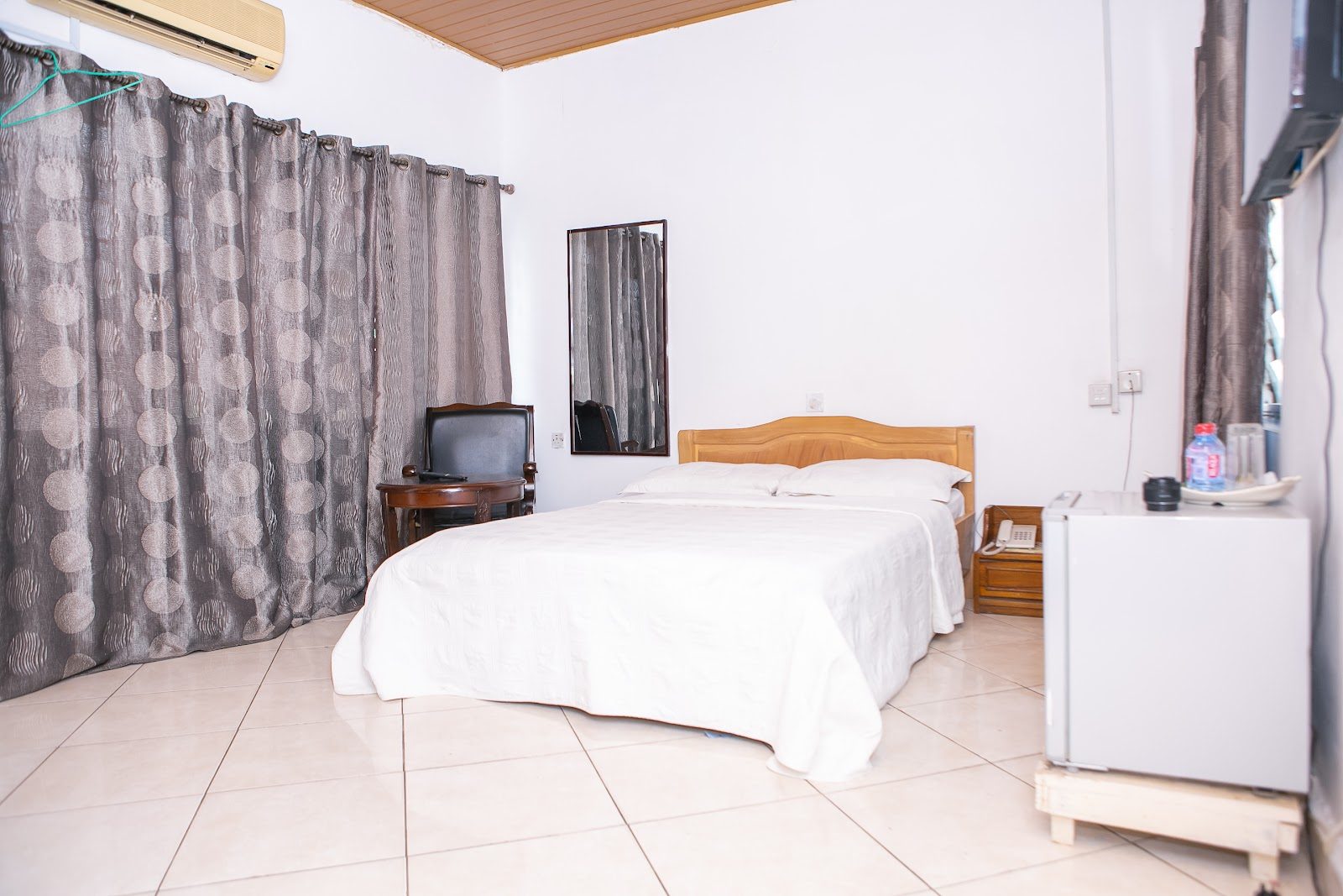 Comfortable double room with television and refrigerator
